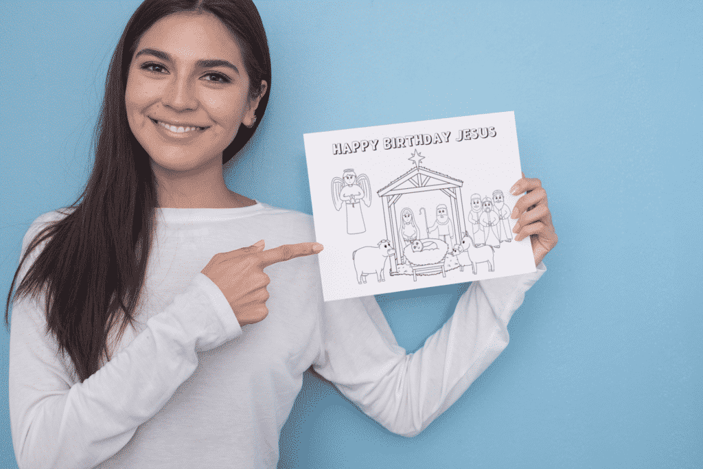 Woman pointing to a Coloring Page with a Nativity Scene that says Happy Birthday Jesus